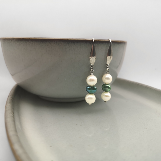 Elevate your style with the timeless charm of the Emerald Tide drop earrings.