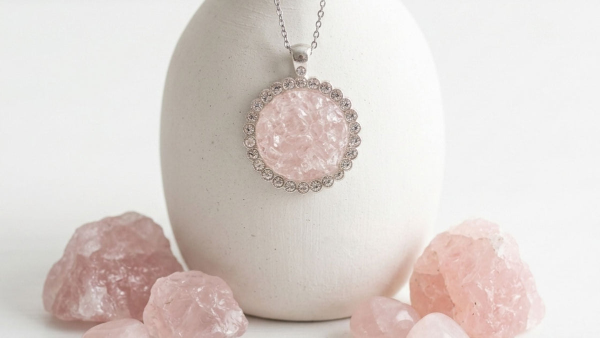 Crushed rose quartz silver necklace on a white ceramic vase