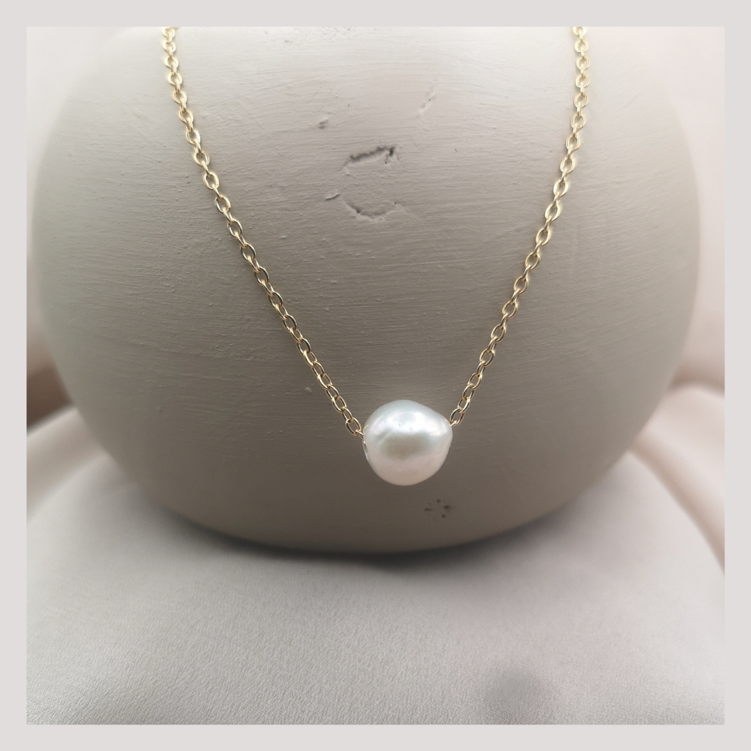 Floating white natural pearl necklaces on a gold plated stainless steel chain
