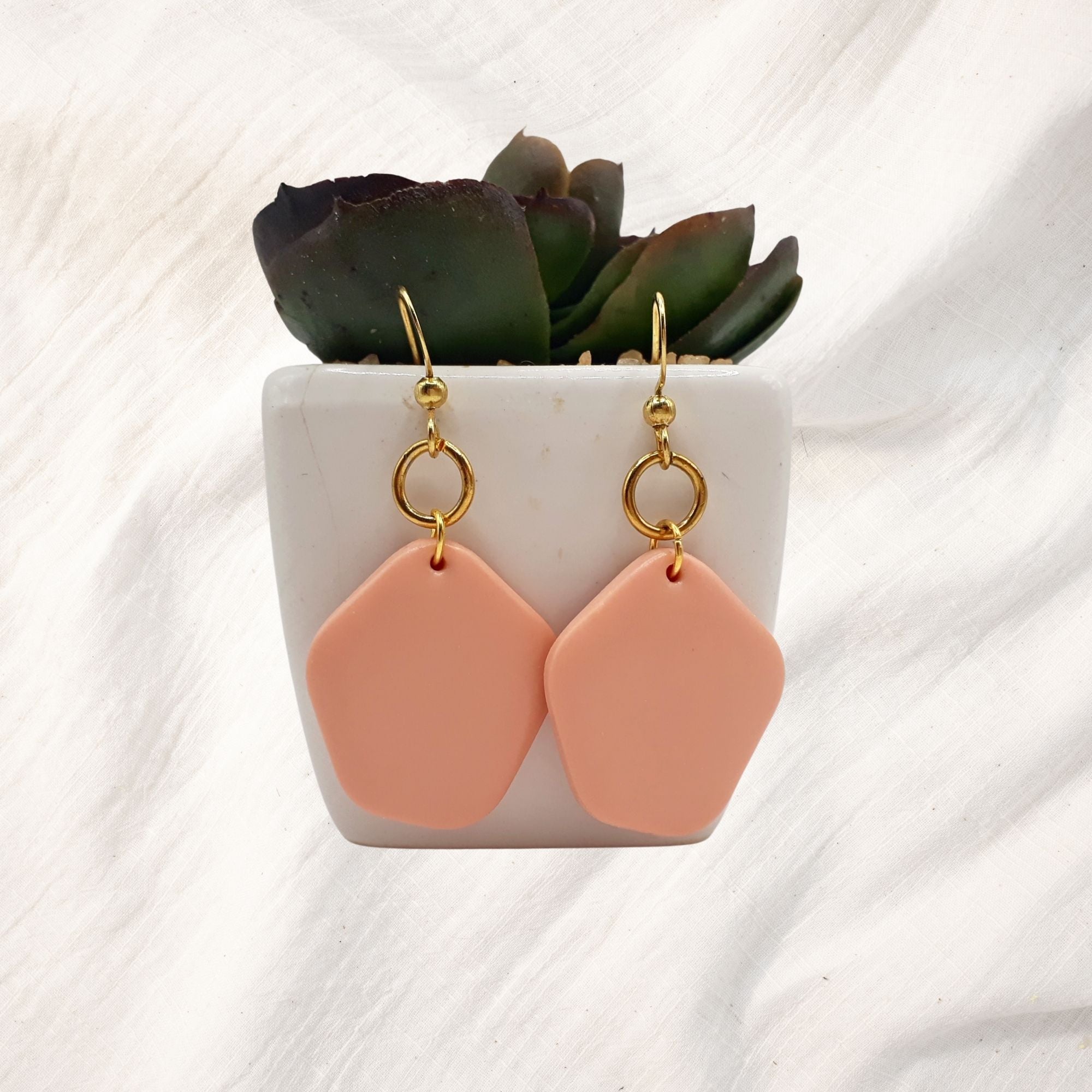 “Handmade clay earrings collection featuring colorful, lightweight statement jewelry in modern designs.