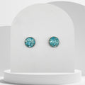 Stainless steel stud earrings with 12mm bezel set crushed turquoise gemstones sealed in glass-like resin