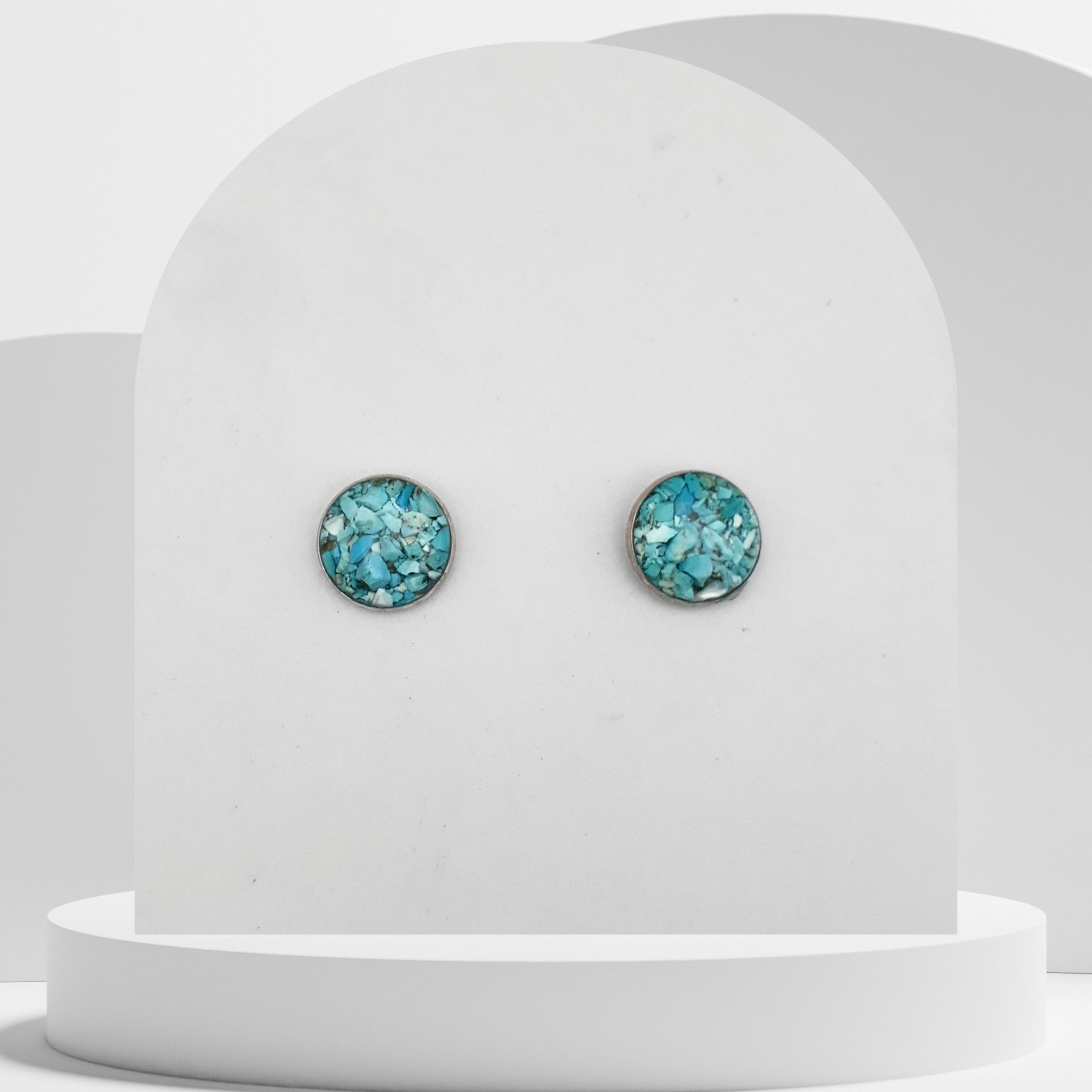 Stainless steel stud earrings with 12mm bezel set crushed turquoise gemstones sealed in glass-like resin