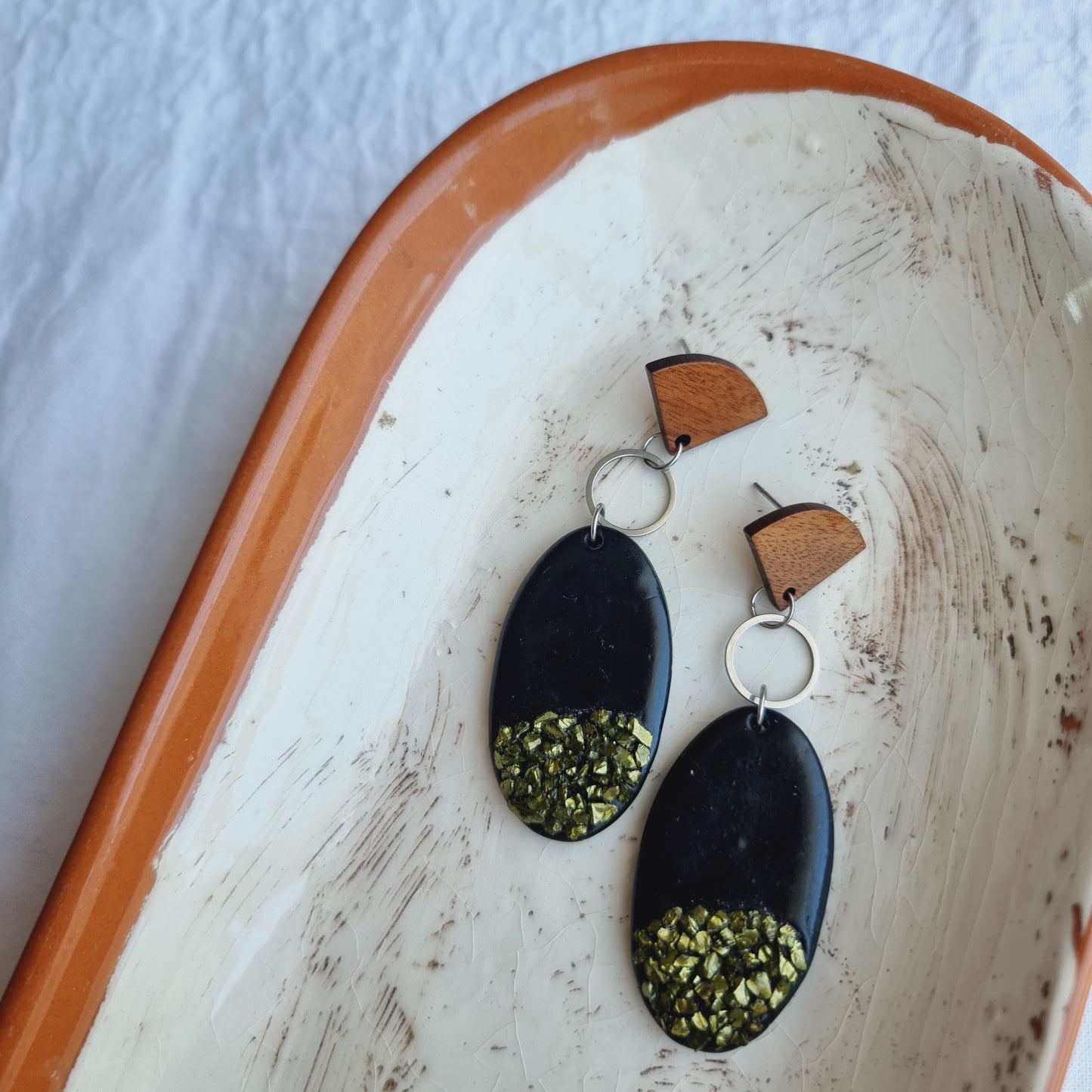 Elegant and unique, these handmade Polymer Clay Earrings bring luxury sophistication to any look. Crafted from oval black polymer clay with golden chips