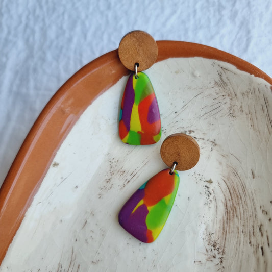 These handmade triangle polymer clay earrings will add a fun, bright splash of color to your look.