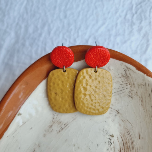 These conversation-spurring earrings will turn heads at any event! Handmade in a fun mix of red and mustard polymer clay and stainless steel, you won't have to worry about sensitivity.