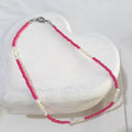  This handmade necklace pairs the soft lustre of freshwater rice pearls with vibrant cerise pink glass beads. 