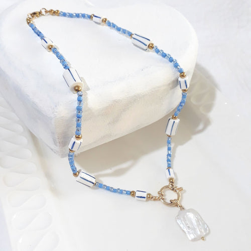 This handmade necklace brings together a white square baroque freshwater pearl, soft blue glass beads and white ceramic beads with blue stripes