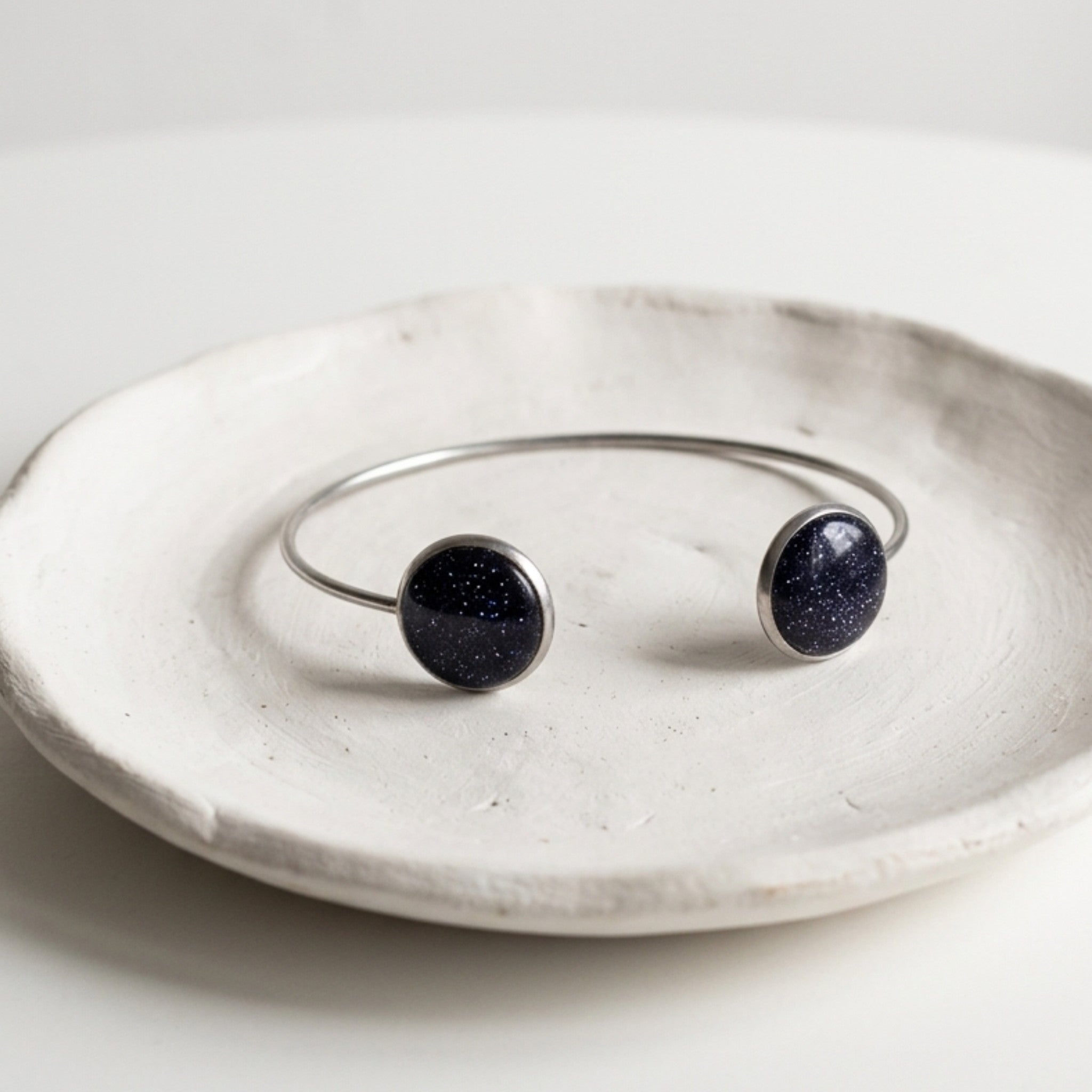 Handmade 304 stainless steel cuff bangle with natural crushed Star Stone 12mm bezel settings and clear resin finish.