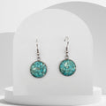 Stainless steel drop earrings with 16mm bezel set crushed turquoise gemstones sealed in glass-like resin on shepherd hooks
