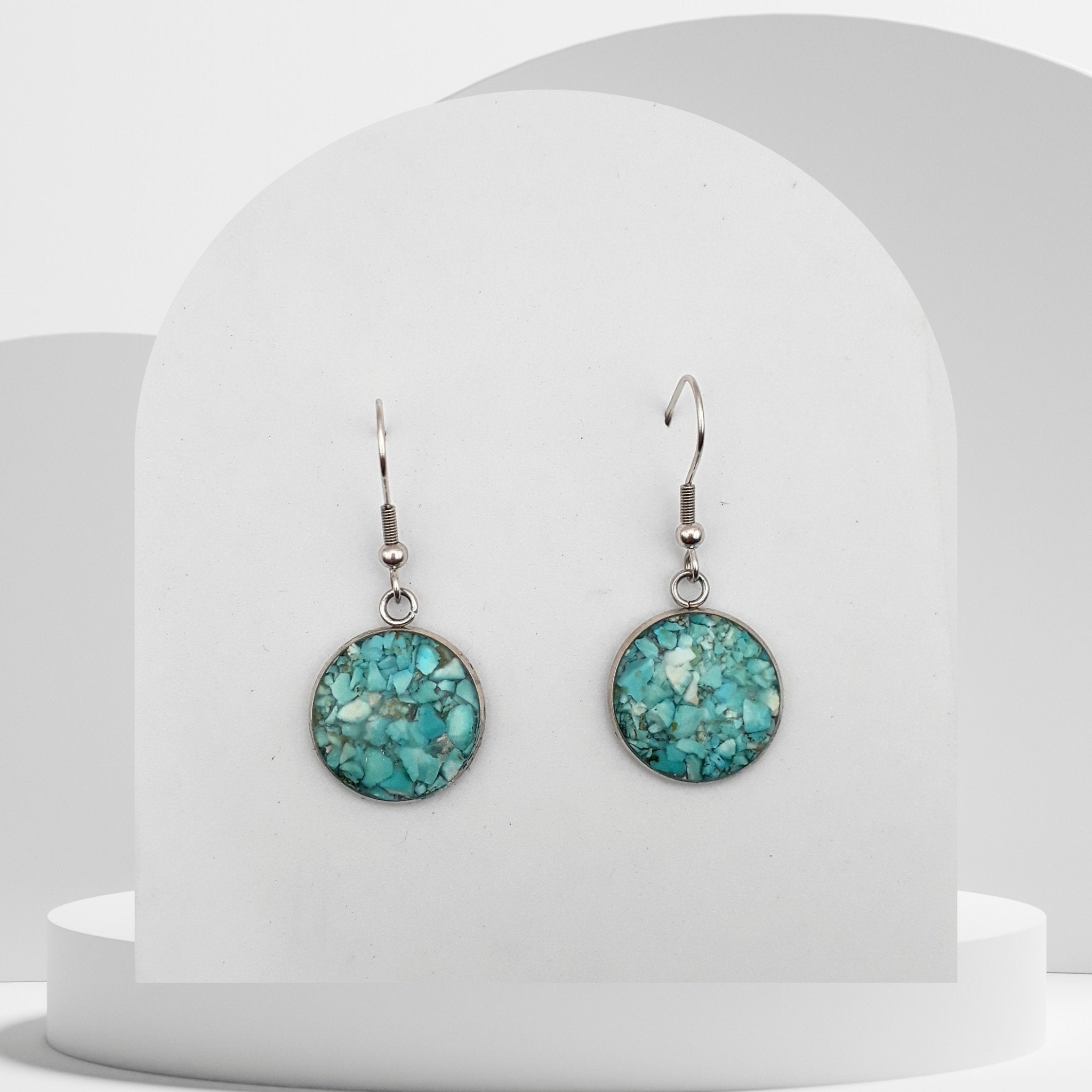 Stainless steel drop earrings with 16mm bezel set crushed turquoise gemstones sealed in glass-like resin on shepherd hooks