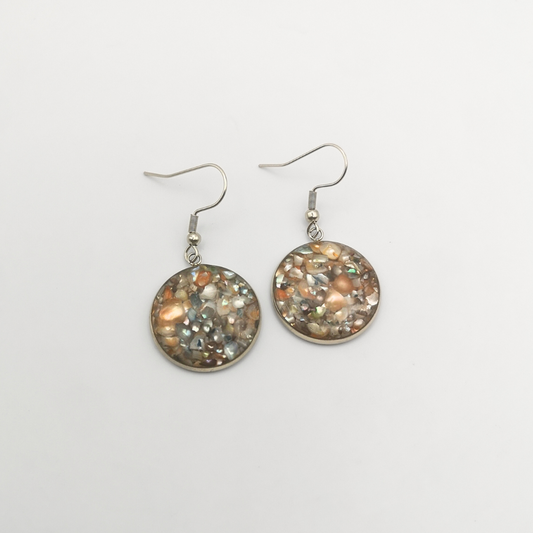Handcrafted earrings feature crushed freshwater pearls delicately set in crystal-clear resin.