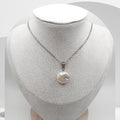 Coin Pearl necklace on a mannequin bust against a white background