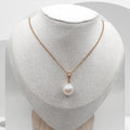 Pearl necklace on a mannequin bust with a white background