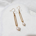 Gold-tone open rectangular bar earrings with white freshwater pearl drops and shepherd ear hooks.