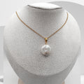 Pearl necklace on a mannequin bust with a white background