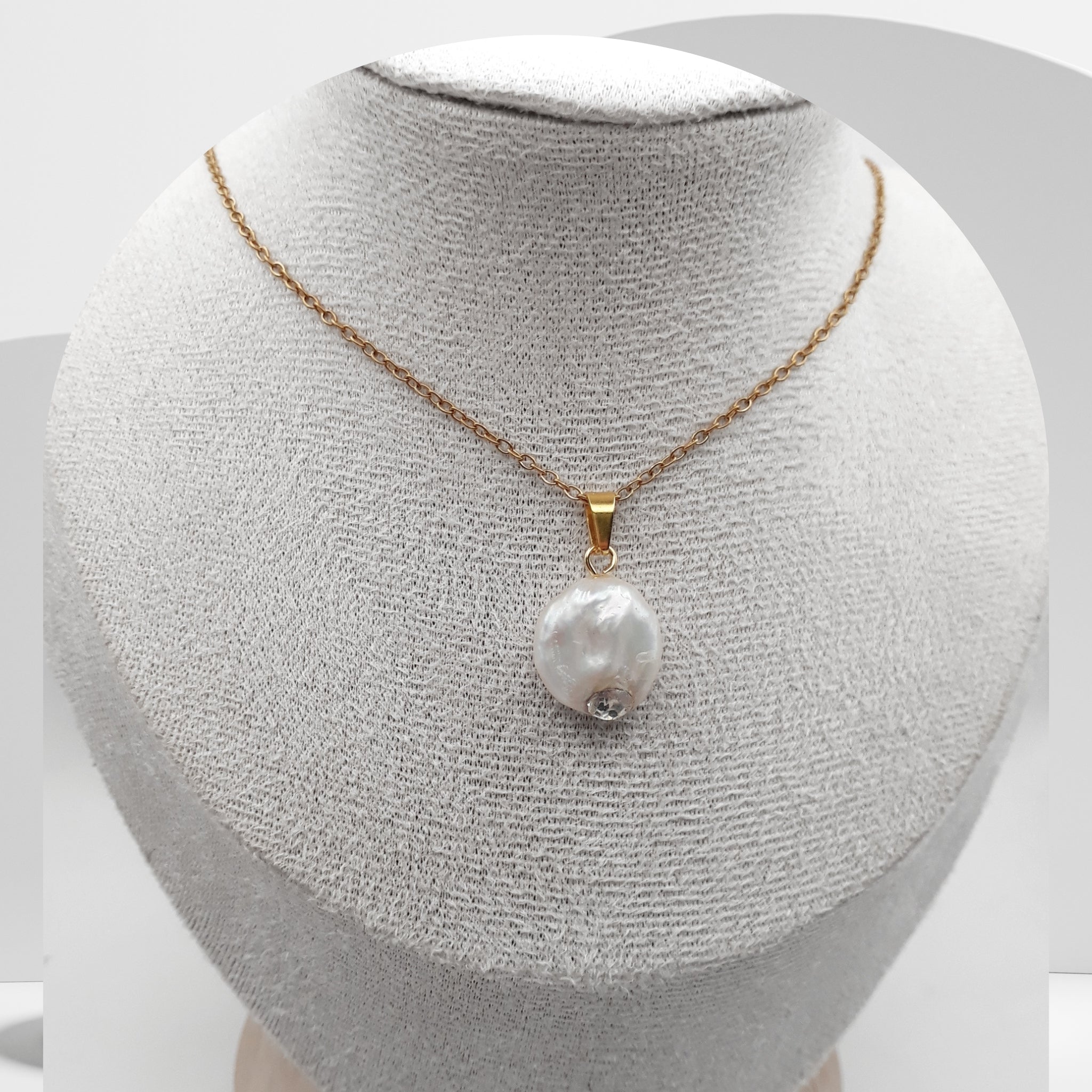 Pearl necklace on a mannequin bust with a white background