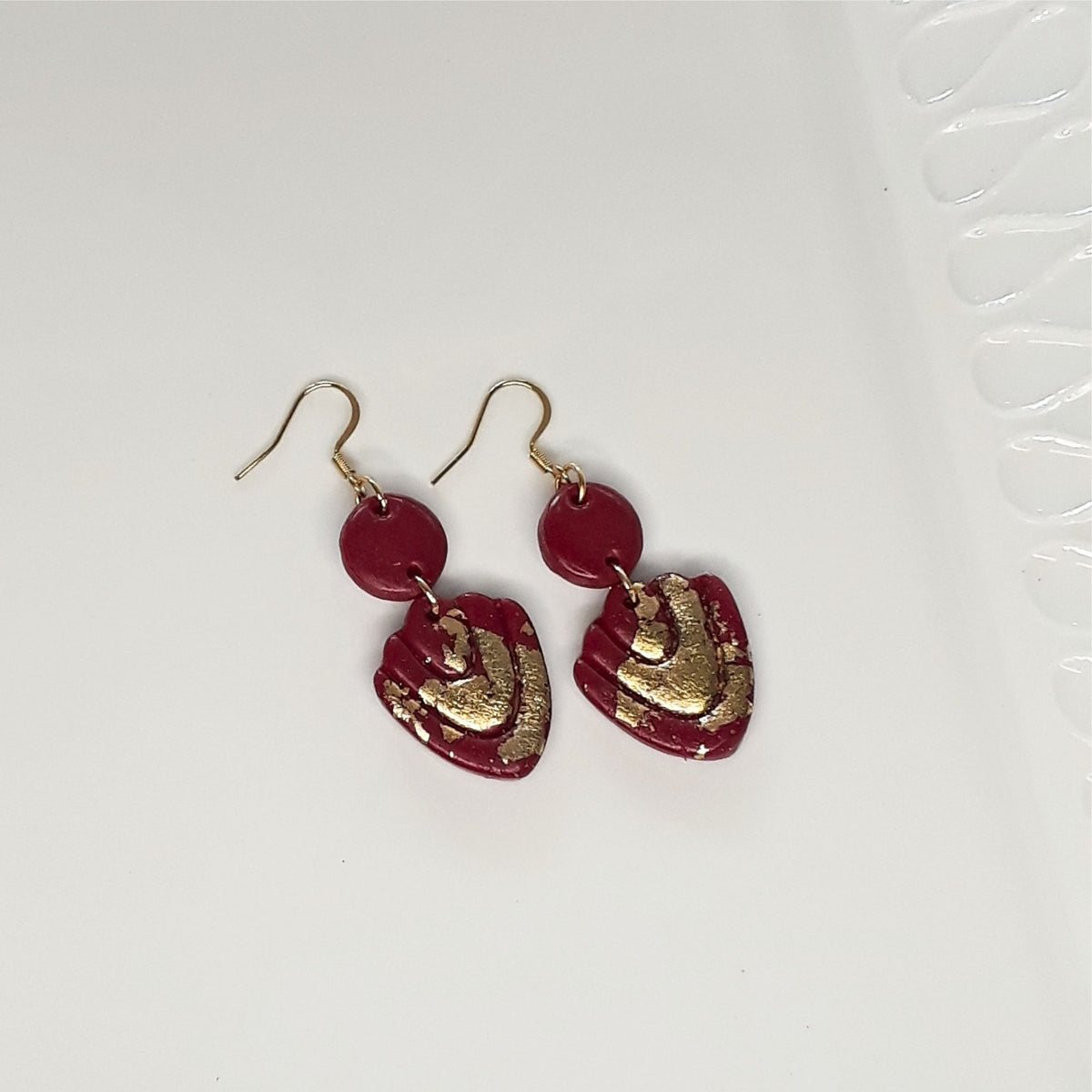 Handcrafted dark maroon polymer clay earrings with gold leaf and 316L stainless steel shepherd ear hooks