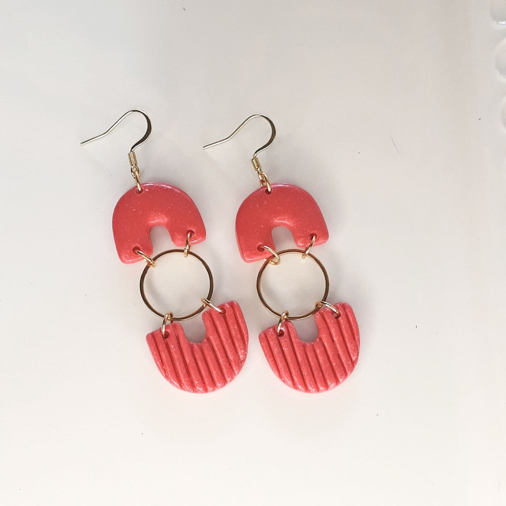 Handmade salmon pink arch and ribbed fan polymer clay dangle earrings with gold plated hardware - product flat lay
