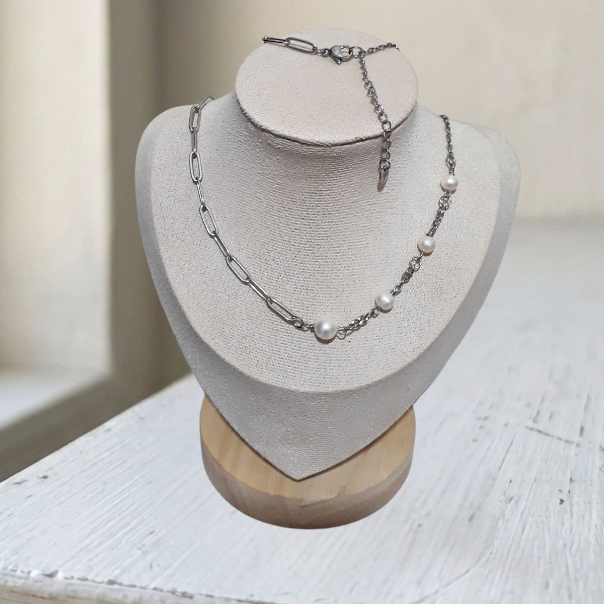 Handcrafted freshwater pearl and mixed paperclip cable chain stainless steel necklace on display bust