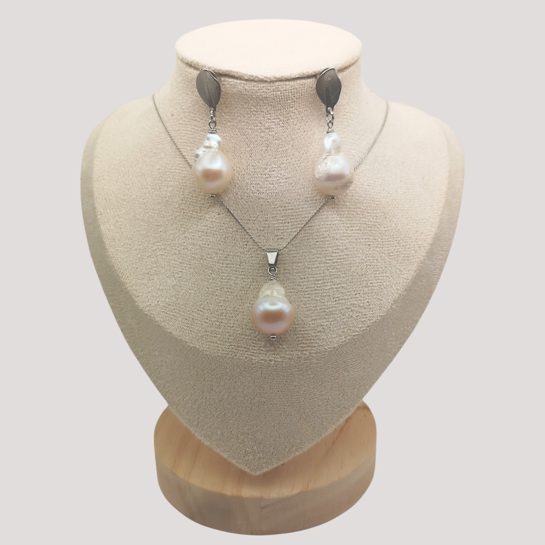 Baroque Pearl necklace and earrings set on a mannequin bust with a plain background