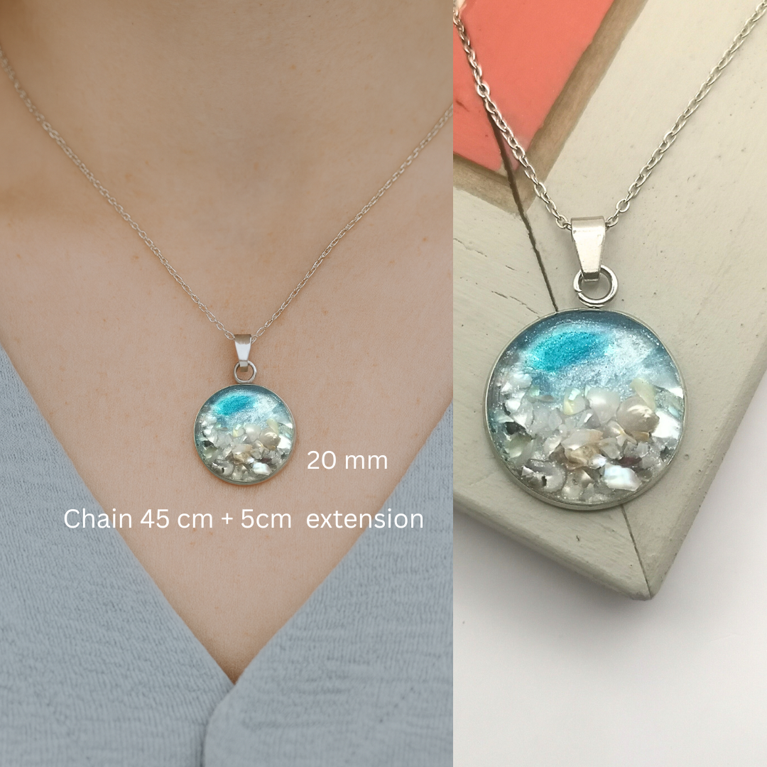 Necklace with a round pendant on a person and a plain background