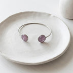 Handmade stainless steel open cuff bangle with crushed Pink Aura Quartz sealed in resin