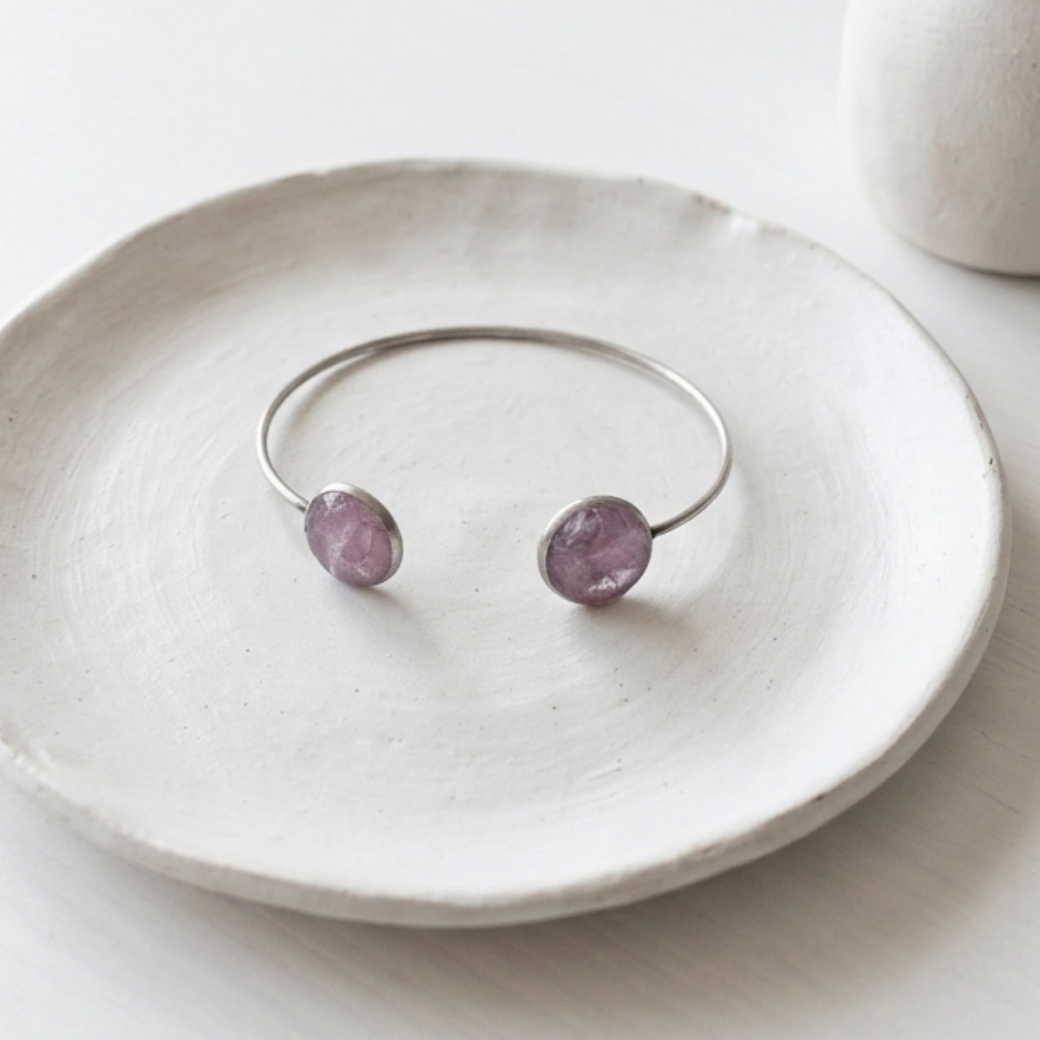 Handmade stainless steel open cuff bangle with crushed Pink Aura Quartz sealed in resin