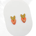 Heart-shaped earrings with gold accents on a white background
