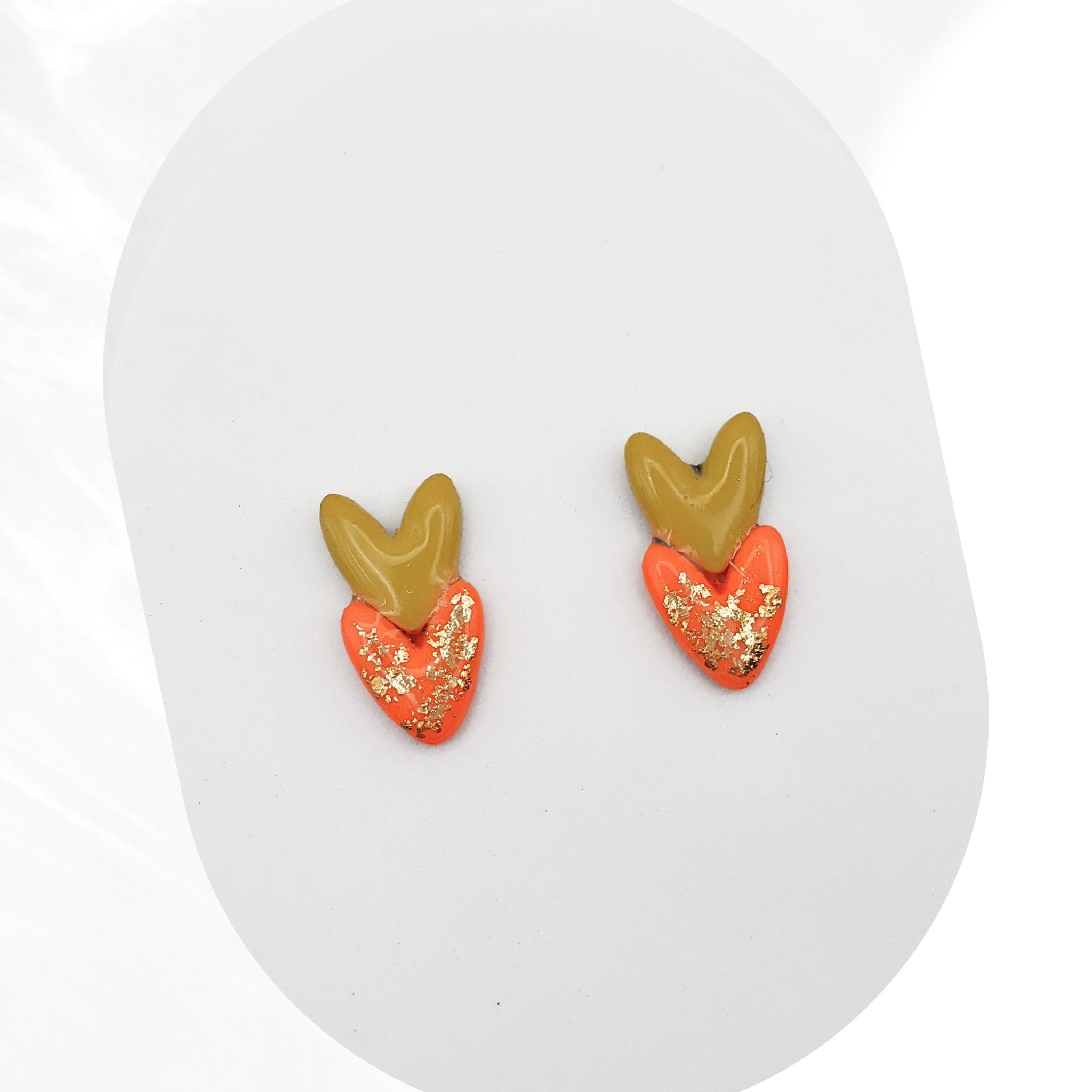 Heart-shaped earrings with gold accents on a white background