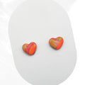 Heart-shaped earrings with a colorful design on a white background