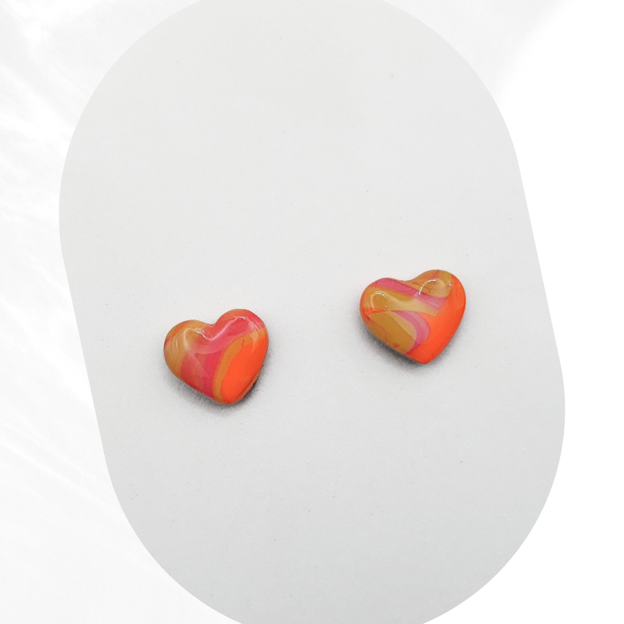 Heart-shaped earrings with a colorful design on a white background