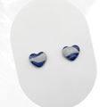 Heart-shaped blue and gray polymer clay earrings on a white background