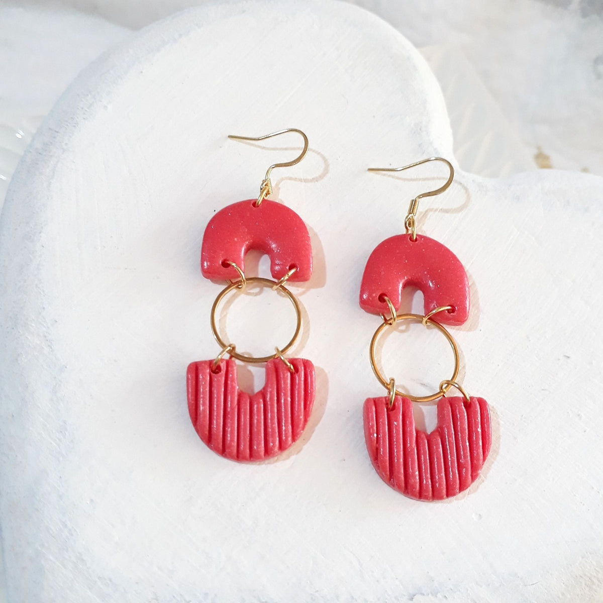 Handmade salmon pink arch and ribbed fan polymer clay dangle earrings with gold plated hardware - product flat lay