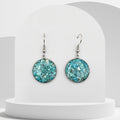 Stainless steel drop earrings with 20mm bezel set crushed turquoise gemstones sealed in glass-like resin on shepherd hooks