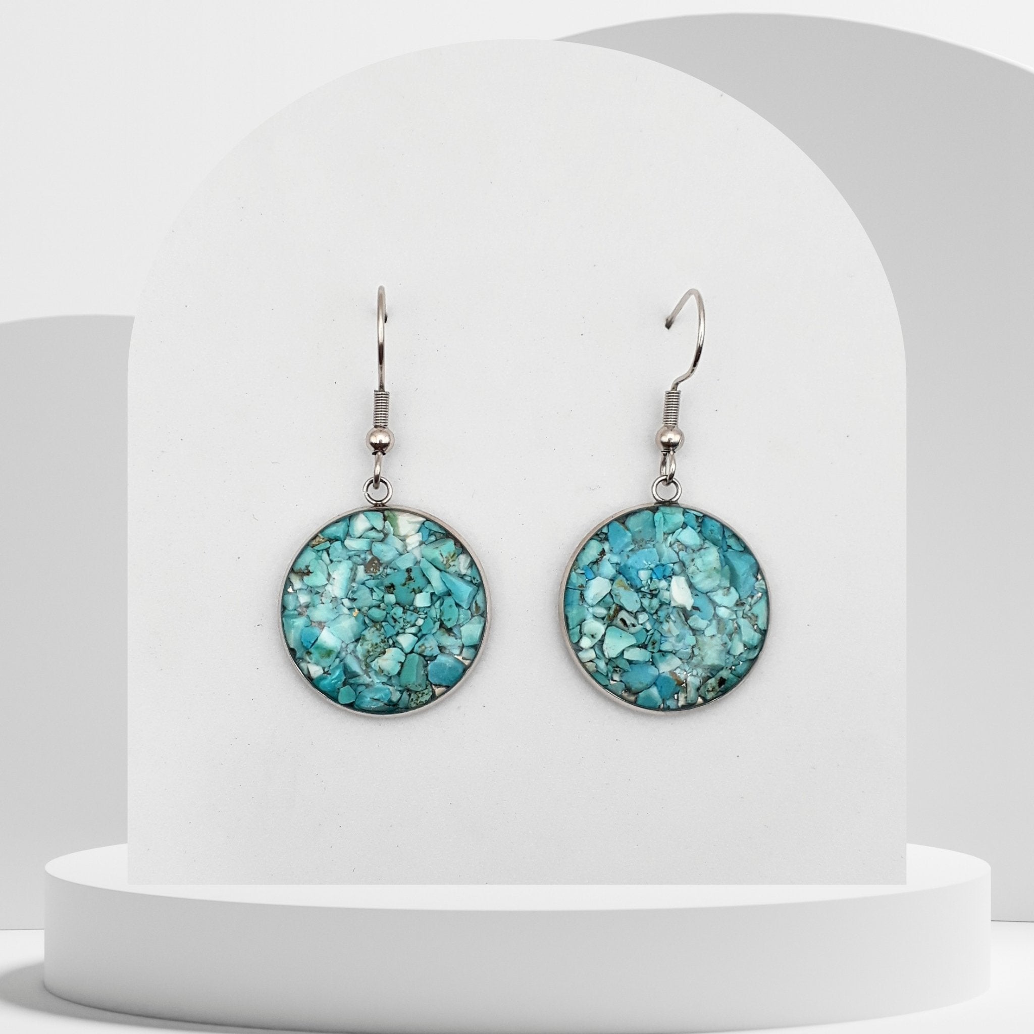 Stainless steel drop earrings with 20mm bezel set crushed turquoise gemstones sealed in glass-like resin on shepherd hooks