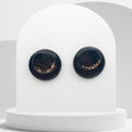 Handmade black polymer clay stud earrings with gold leaf and resin finish