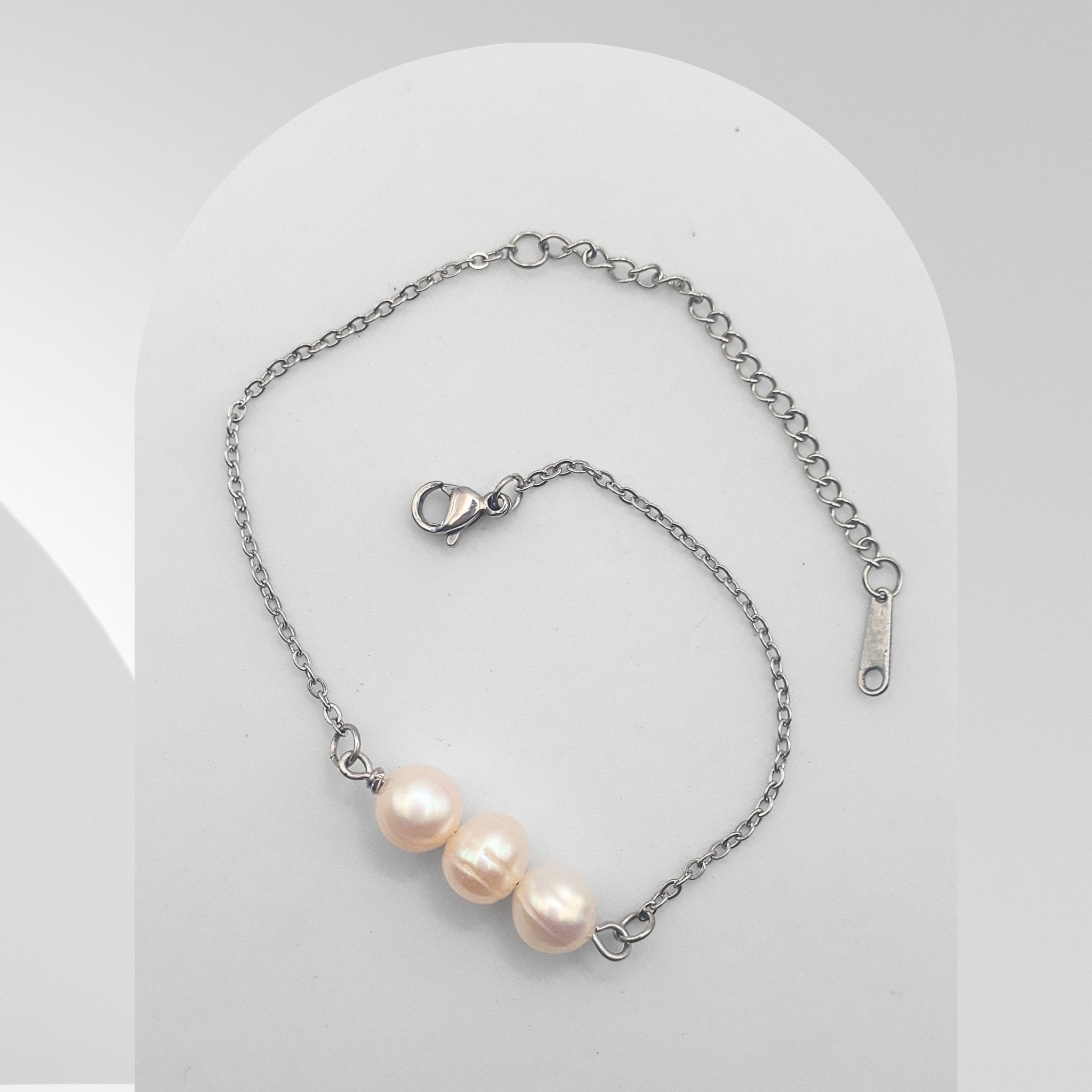 Pearl bracelet with silver chain on a white background