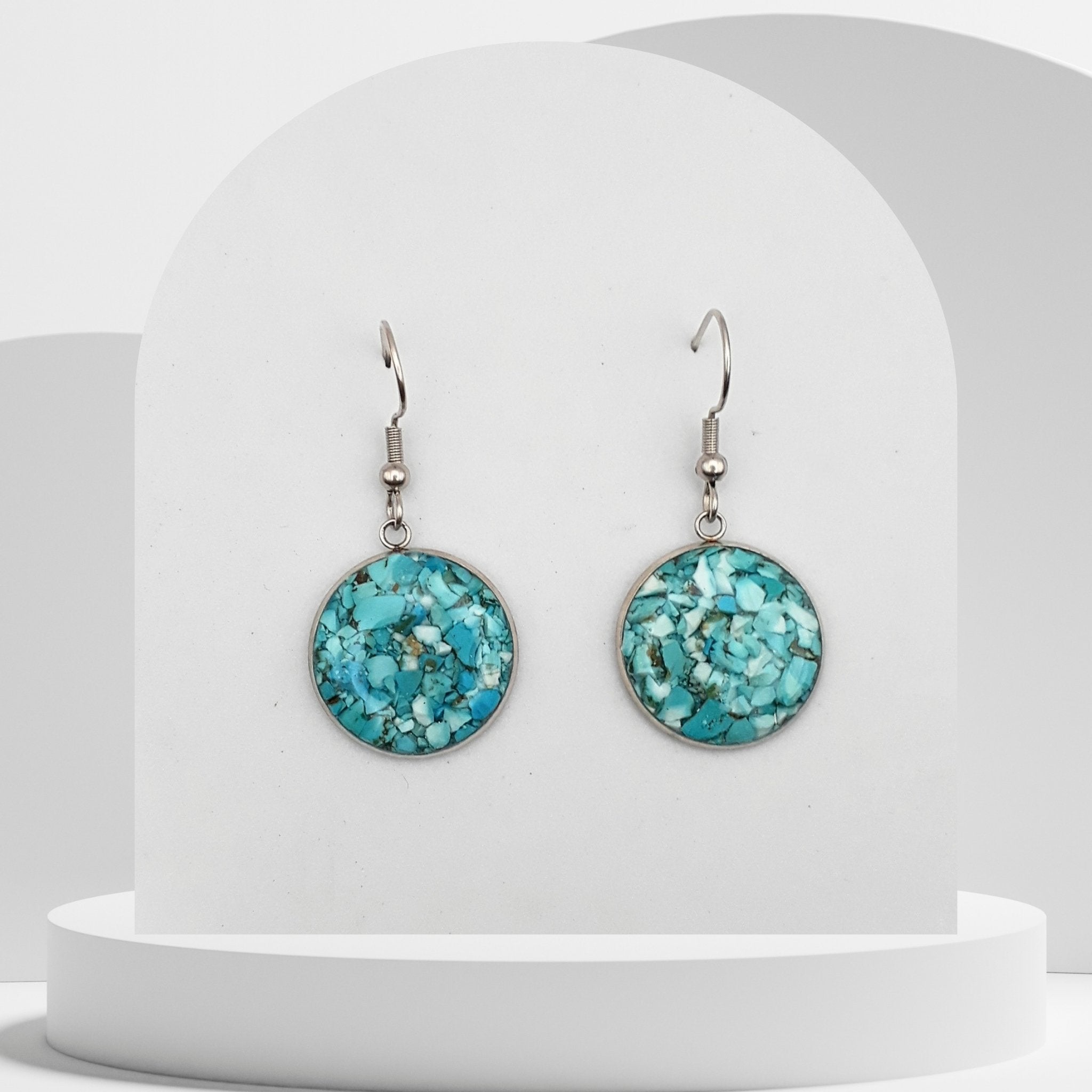 Stainless steel drop earrings with 18mm bezel set crushed turquoise gemstones sealed in glass-like resin on shepherd hooks