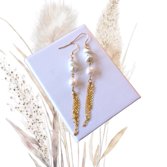 Add a touch of glamour to your look with our golden stainless steel drop earrings adorned with freshwater pearls and Howlite Gemstones.