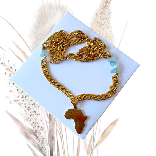 Whether worn alone for a chic look or layered with other necklaces for a trendy style, this Golden Stainless Steel Necklace with Aquamarine Gemstones and a Africa Pendant is a versatile piece that complements any wardrobe.