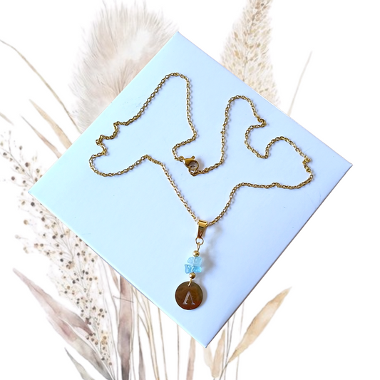 Whether worn alone for a chic minimalist look or layered with other necklaces for a trendy style, this Golden Stainless Steel Necklace with Aquamarine Gemstones and Letter A Pendant is a versatile piece that complements any wardrobe. 