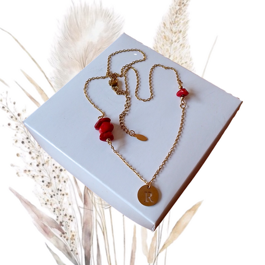 Elevate your neckline with our stunning golden stainless steel necklace with red coral and the letter R. 