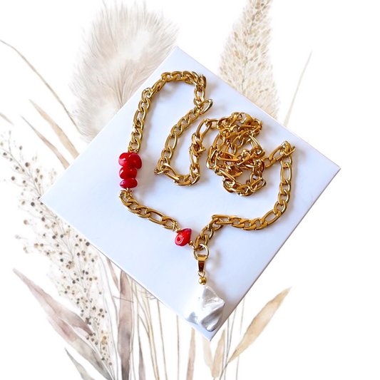 Elevate your neckline with our stunning golden stainless steel necklace with red coral and a baroque shell pearl.