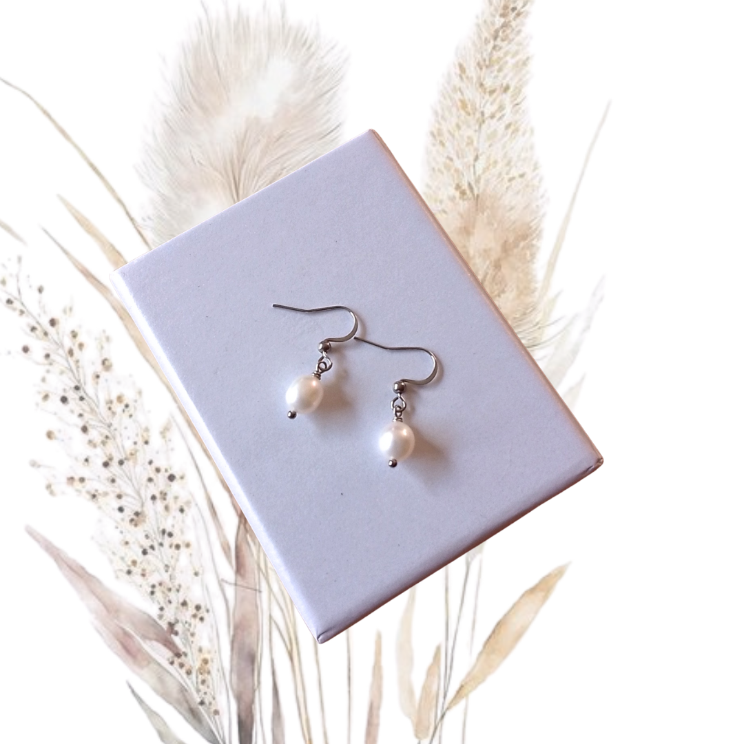 Add a touch of sophistication to any outfit with our handmade White Freshwater Pearl Drop Earrings.