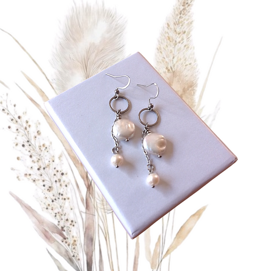 Indulge in pure elegance with our White Freshwater Pearl Dangle Earrings. Featuring a 4 mm round freshwater pearl and a 7mm coin pearl, these earrings exude sophistication.