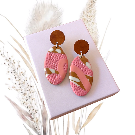 Indulge in decadent elegance with our Polymer Clay Oval Drop Earrings. These one of a kind earrings were thoughtfully handmade with pink, brown and white clay, exquisitely paired with Walnut Wood round ear studs and a stainless steel pin