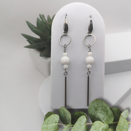 Indulge in timeless elegance with our Natural White Stone Stainless Steel Dangle Earrings.