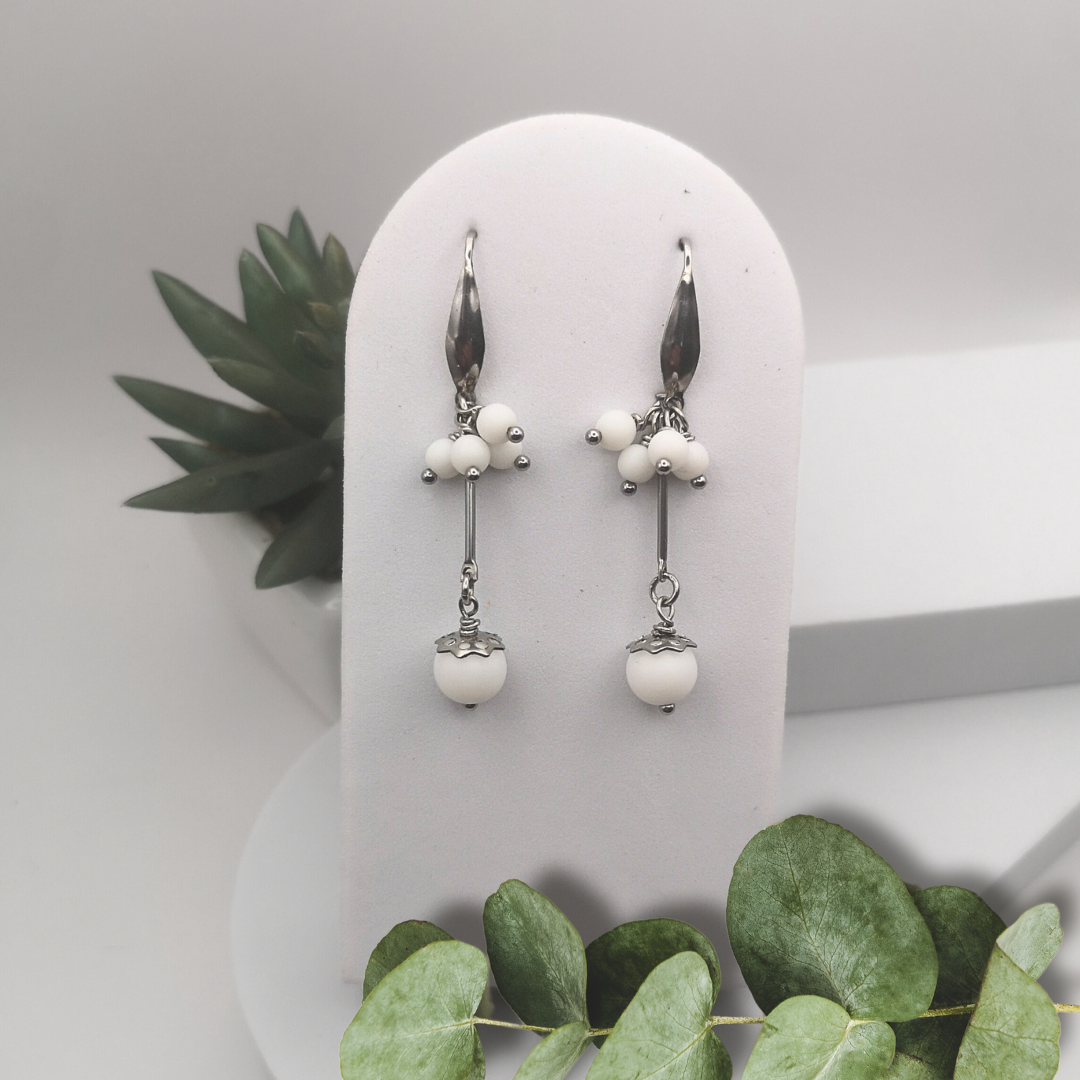 Elevate your style with our Natural White Stone Stainless Steel Dangle Earrings.