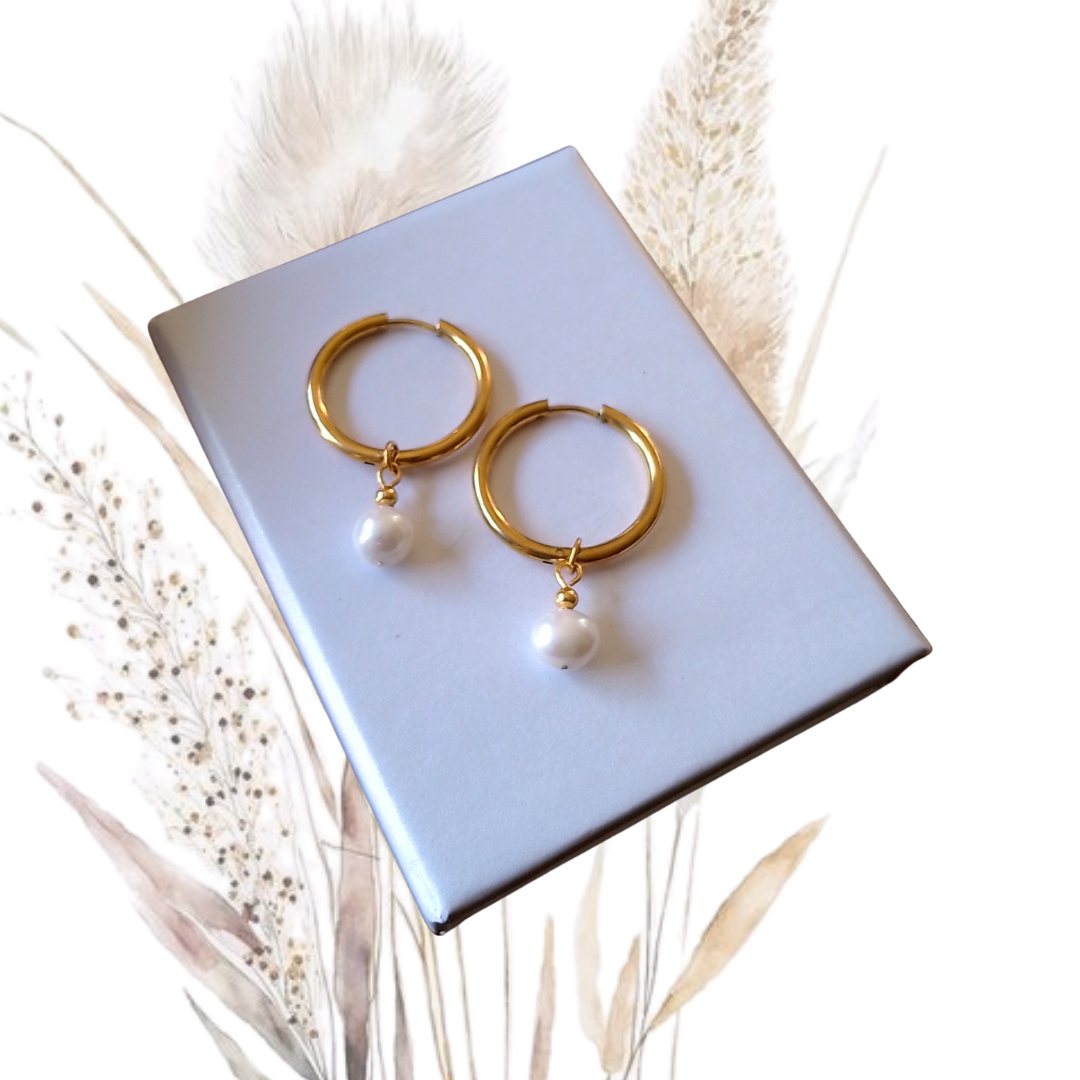 Our stunning Gold Stainless Steel Hoop Earrings, featuring exquisite white freshwater pearls measuring 7mm in diameter. 