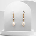 Freshwater Pearl gold‑plated stainless steel earrings feature a natural white 7 mm pear‑shaped pearl suspended from a small ceramic heart.